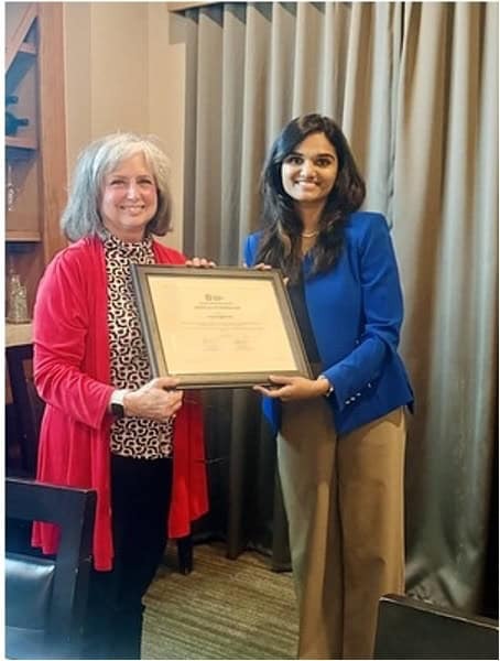 Two attendees presenting a framed certificate at the May 2026 Neuro-Degenerative Disorders Journal Club.