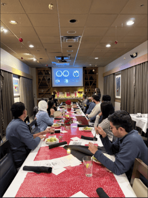 Attendees seated around a table during the December 2025 Stroke Journal Club.